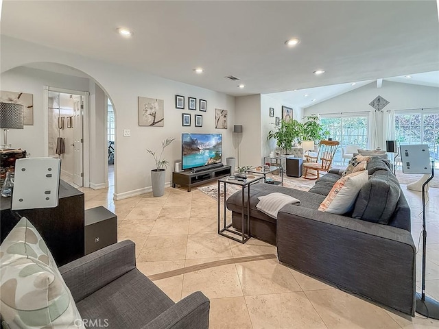 24017 Sylvan St, Woodland Hills, CA 91367 - living area featuring arched walkways, vaulted ceiling, light tile patterned flooring, and recessed lighting
