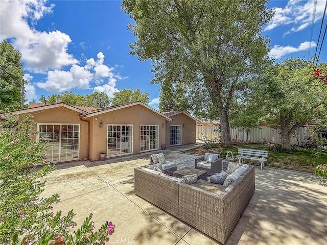 24017 Sylvan St, Woodland Hills, CA 91367 - rear view of house featuring stucco siding, a patio, an outdoor hangout area, and french doors