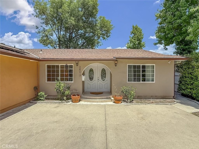 24017 Sylvan St, Woodland Hills, CA 91367 - entrance to property with stucco siding and roof with shingles