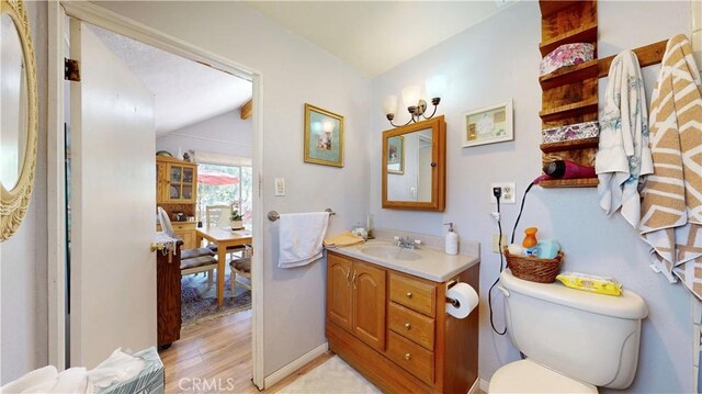 23728 Manzanita Dr, Crestline, CA 92325 - bathroom featuring vanity, wood finished floors, and vaulted ceiling