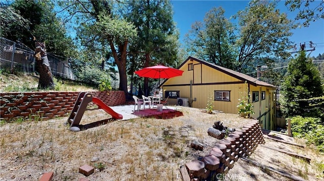 23728 Manzanita Dr, Crestline, CA 92325 - rear view of house featuring a patio area