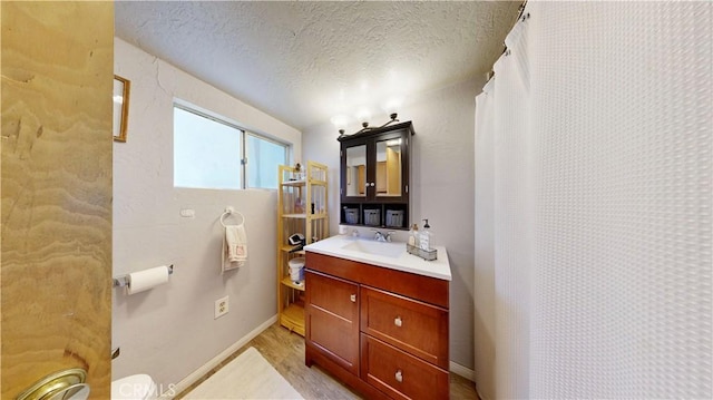 23728 Manzanita Dr, Crestline, CA 92325 - full bathroom featuring vanity, wood finished floors, a textured ceiling, and a shower with curtain