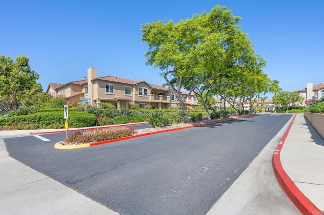 6104 Citracado Cir, Carlsbad, CA 92009 - view of asphalt road with a residential view, sidewalks, and curbs