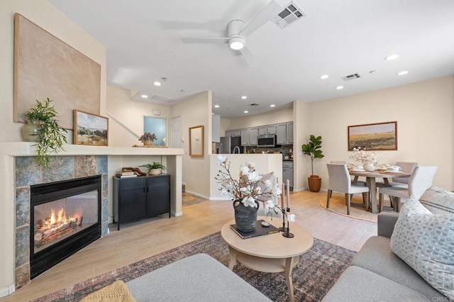 6104 Citracado Cir, Carlsbad, CA 92009 - living room featuring light wood finished floors, ceiling fan, a tile fireplace, and recessed lighting