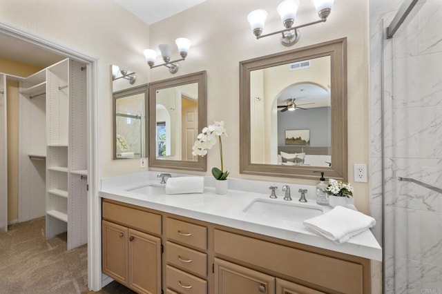 6104 Citracado Cir, Carlsbad, CA 92009 - full bath with double vanity, a walk in closet, a marble finish shower, and ceiling fan