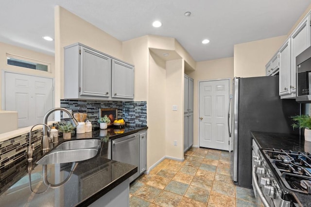 6104 Citracado Cir, Carlsbad, CA 92009 - kitchen featuring stainless steel appliances, decorative backsplash, stone tile floors, dark stone counters, and recessed lighting