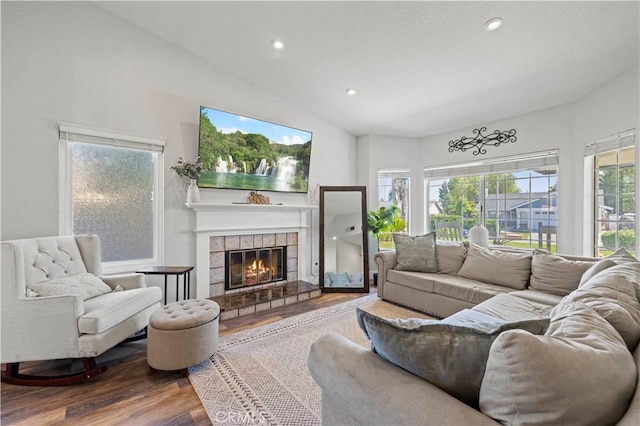 27724 Crookshank Dr, Saugus, CA 91350 - living room featuring wood finished floors, a tile fireplace, lofted ceiling, and recessed lighting