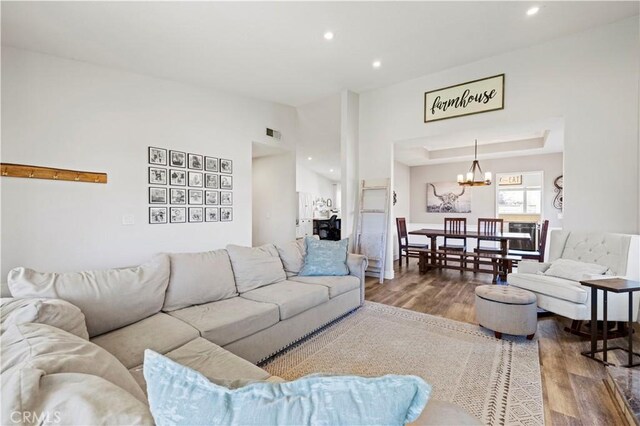 27724 Crookshank Dr, Saugus, CA 91350 - living room featuring wood finished floors, a chandelier, recessed lighting, and lofted ceiling
