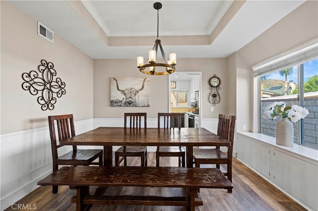 27724 Crookshank Dr, Saugus, CA 91350 - dining space with wood finished floors, a raised ceiling, a chandelier, and ornamental molding