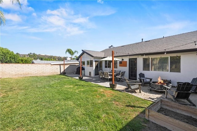 27724 Crookshank Dr, Saugus, CA 91350 - back of house featuring a fire pit, a patio, a vegetable garden, stucco siding, and a shingled roof