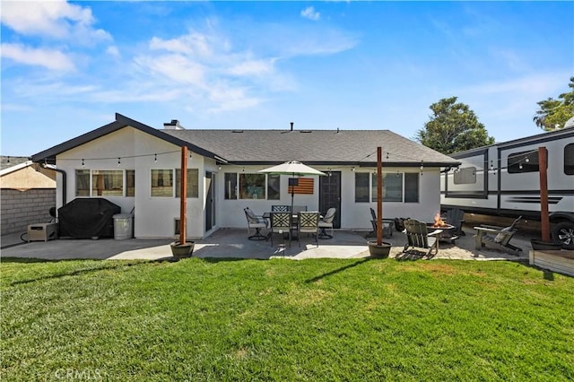 27724 Crookshank Dr, Saugus, CA 91350 - back of house featuring a patio area, a lawn, an outdoor fire pit, and a chimney