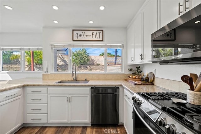 27724 Crookshank Dr, Saugus, CA 91350 - kitchen featuring appliances with stainless steel finishes, white cabinetry, dark wood finished floors, recessed lighting, and light stone counters