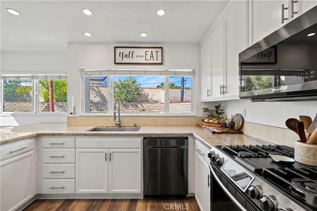27724 Crookshank Dr, Saugus, CA 91350 - kitchen featuring stainless steel appliances, white cabinetry, dark wood-type flooring, recessed lighting, and light stone countertops