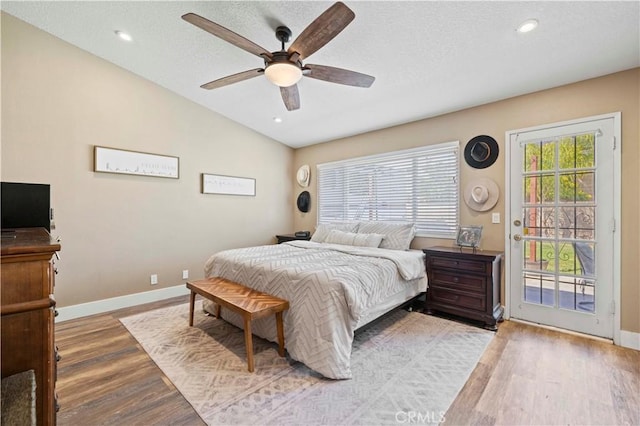 27724 Crookshank Dr, Saugus, CA 91350 - bedroom featuring access to outside, wood finished floors, vaulted ceiling, recessed lighting, and a textured ceiling