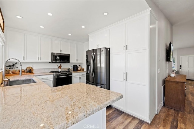 27724 Crookshank Dr, Saugus, CA 91350 - kitchen featuring appliances with stainless steel finishes, wood finished floors, white cabinets, light stone countertops, and recessed lighting