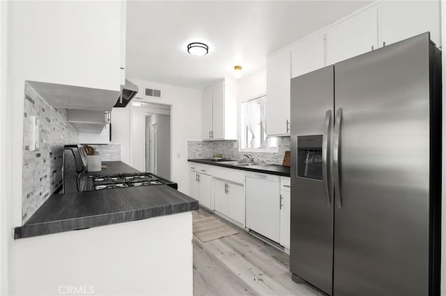 7729 Sedan Ave, West Hills, CA 91304 - kitchen featuring stainless steel fridge, dark countertops, white dishwasher, and decorative backsplash