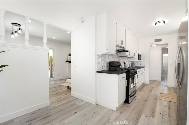 7729 Sedan Ave, West Hills, CA 91304 - kitchen with appliances with stainless steel finishes, under cabinet range hood, light wood-style flooring, tasteful backsplash, and dark countertops