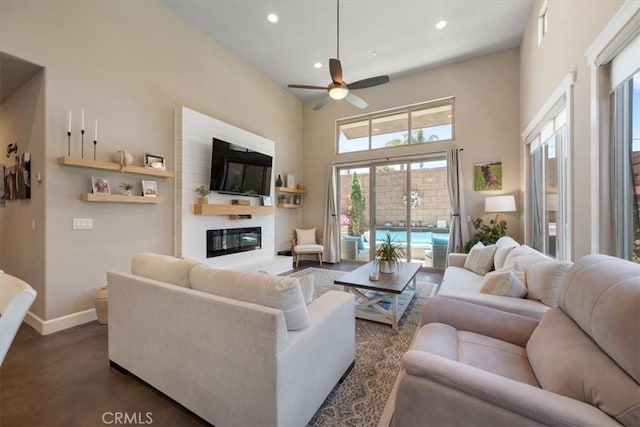 1638 Monterey Ave, Grover Beach, CA 93433 - living room with recessed lighting, ceiling fan, a glass covered fireplace, and a towering ceiling