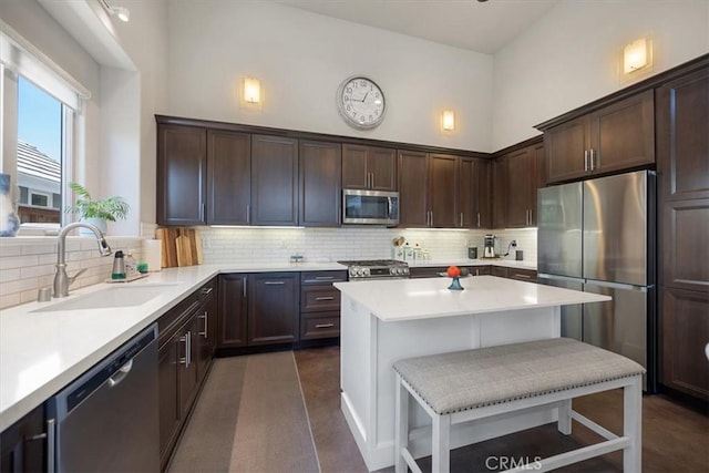1638 Monterey Ave, Grover Beach, CA 93433 - kitchen with stainless steel appliances, dark brown cabinets, decorative backsplash, and light countertops