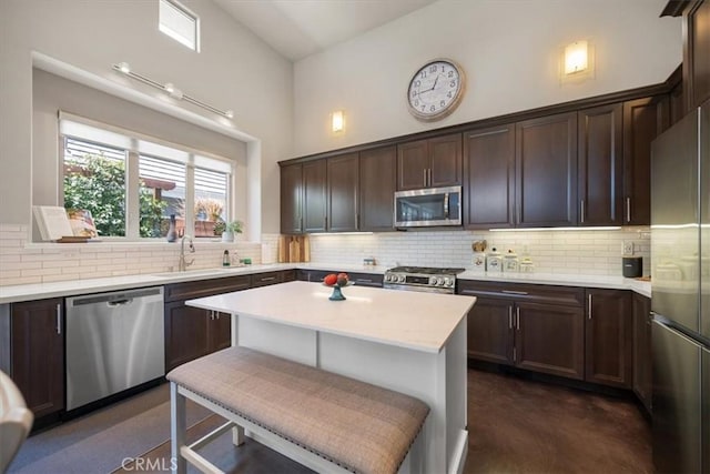 1638 Monterey Ave, Grover Beach, CA 93433 - kitchen featuring stainless steel appliances, backsplash, dark brown cabinetry, and a center island
