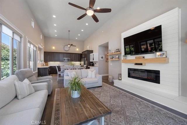 1638 Monterey Ave, Grover Beach, CA 93433 - living room featuring a ceiling fan, a towering ceiling, a glass covered fireplace, and recessed lighting
