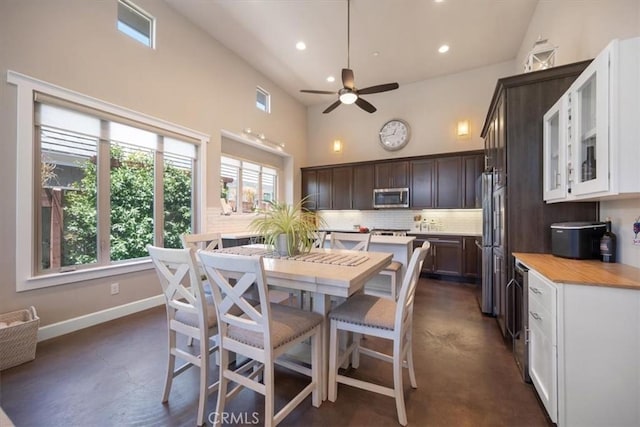 1638 Monterey Ave, Grover Beach, CA 93433 - dining area with a ceiling fan, high vaulted ceiling, finished concrete floors, and recessed lighting