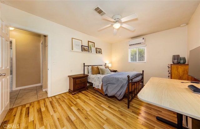 35147 Date Ave, Yucaipa, CA 92399 - bedroom with a wall mounted AC, light wood-type flooring, and a ceiling fan