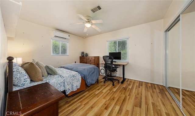 35147 Date Ave, Yucaipa, CA 92399 - bedroom with a wall unit AC, light wood-style flooring, and a ceiling fan