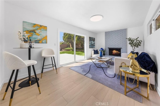 14537 Rath St, La Puente, CA 91744 - living area with wood finished floors, plenty of natural light, and a brick fireplace