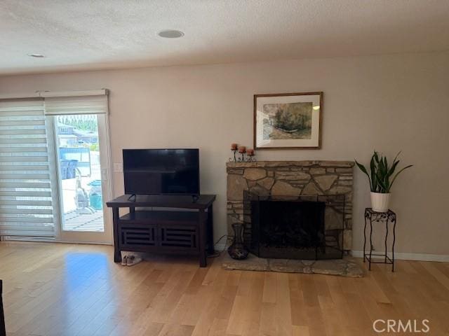 1640 Valencia Ave, Placentia, CA 92870 - living area with wood finished floors, a fireplace, and a textured ceiling
