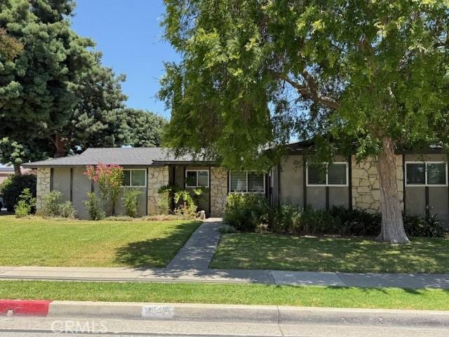 1640 Valencia Ave, Placentia, CA 92870 - view of front of house with stone siding, a front lawn, and stucco siding