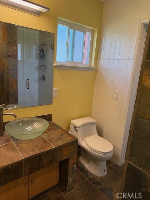 1640 Valencia Ave, Placentia, CA 92870 - bathroom with tile patterned floors, vanity, and a stall shower