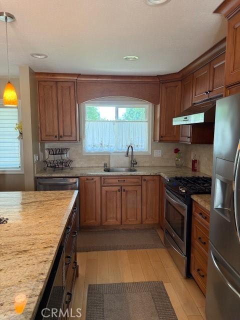 1640 Valencia Ave, Placentia, CA 92870 - kitchen featuring stainless steel appliances, under cabinet range hood, light wood-style floors, brown cabinetry, and recessed lighting