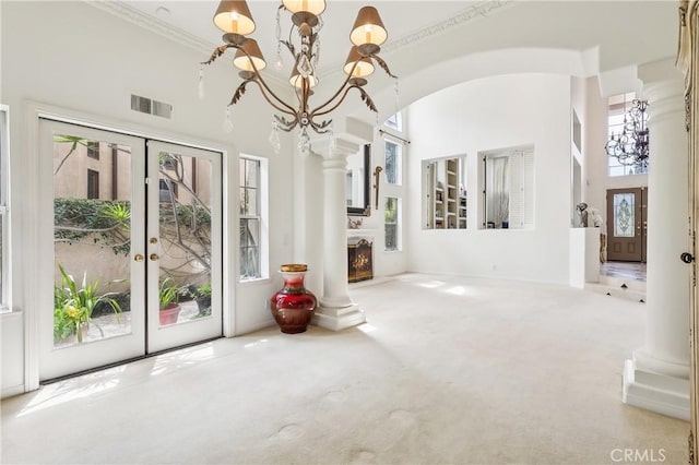 26942 Willow Tree Ln, Laguna Hills, CA 92653 - unfurnished living room with a towering ceiling, french doors, a chandelier, and carpet floors