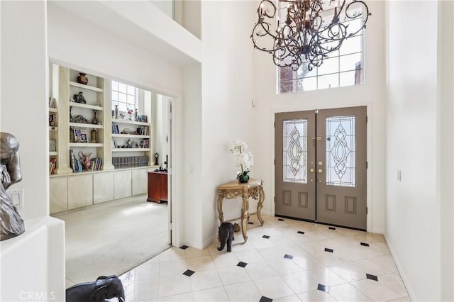 26942 Willow Tree Ln, Laguna Hills, CA 92653 - entrance foyer featuring a chandelier, french doors, a towering ceiling, and tile patterned flooring