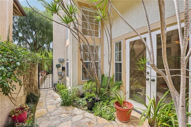 26942 Willow Tree Ln, Laguna Hills, CA 92653 - entrance to property with french doors, a gate, and stucco siding