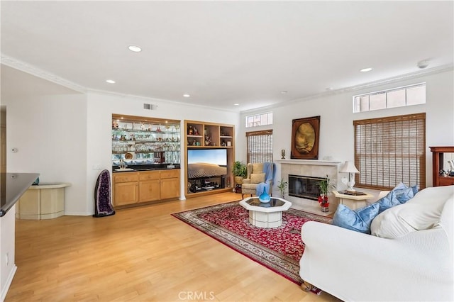 26942 Willow Tree Ln, Laguna Hills, CA 92653 - living area with crown molding, light wood-style flooring, a fireplace, recessed lighting, and bar