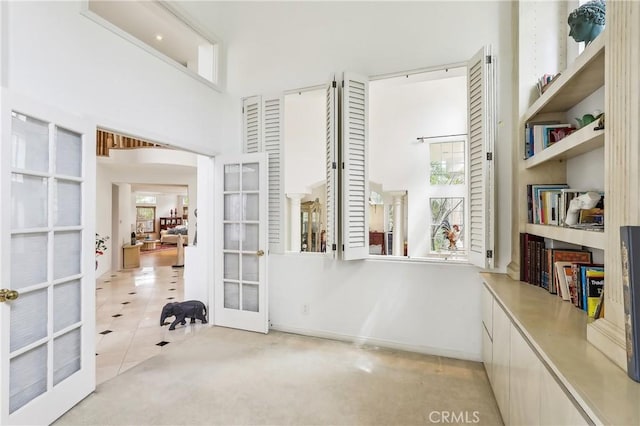 26942 Willow Tree Ln, Laguna Hills, CA 92653 - unfurnished office with french doors, a high ceiling, carpet, and tile patterned flooring