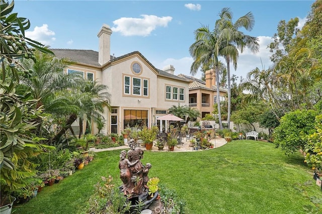 26942 Willow Tree Ln, Laguna Hills, CA 92653 - rear view of property with a chimney, a patio, a lawn, and stucco siding