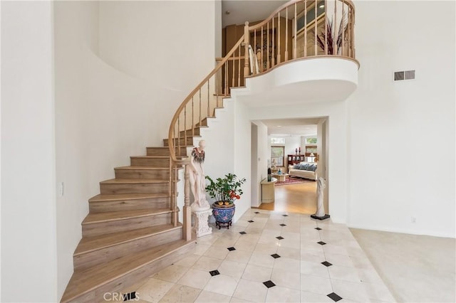 26942 Willow Tree Ln, Laguna Hills, CA 92653 - stairway featuring a high ceiling and tile patterned flooring