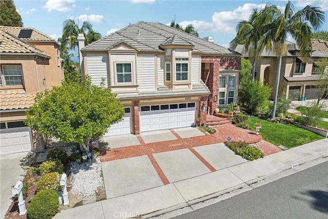 26942 Willow Tree Ln, Laguna Hills, CA 92653 - view of front of house featuring concrete driveway, a garage, and a tiled roof