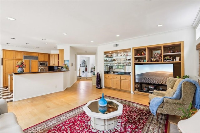 26942 Willow Tree Ln, Laguna Hills, CA 92653 - living room with light wood finished floors, recessed lighting, crown molding, and bar area