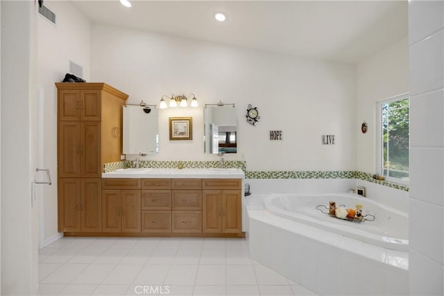 4766 Egret Ln, Paso Robles, CA 93446 - bathroom featuring a bath, double vanity, tile patterned flooring, and recessed lighting