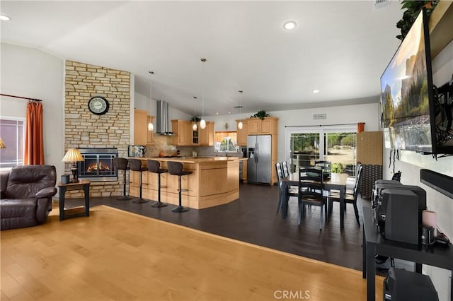 4766 Egret Ln, Paso Robles, CA 93446 - dining area with lofted ceiling, a fireplace, dark wood-style floors, and recessed lighting
