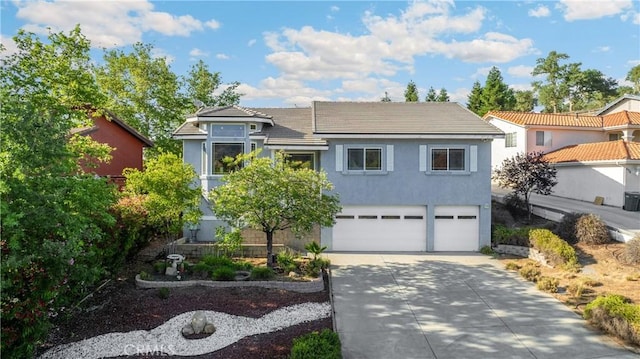 4766 Egret Ln, Paso Robles, CA 93446 - view of front of house with driveway, an attached garage, stucco siding, and a tiled roof