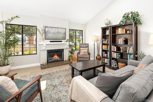 5550 La Cuenta Dr, San Diego, CA 92124 - living area with wood finished floors, a glass covered fireplace, and high vaulted ceiling