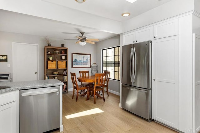 5550 La Cuenta Dr, San Diego, CA 92124 - kitchen featuring appliances with stainless steel finishes, white cabinetry, light wood-type flooring, a ceiling fan, and light countertops