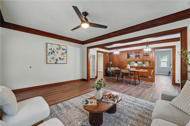 8680 Evergreen Ave, South Gate, CA 90280 - living room with wood finished floors, ceiling fan, and crown molding