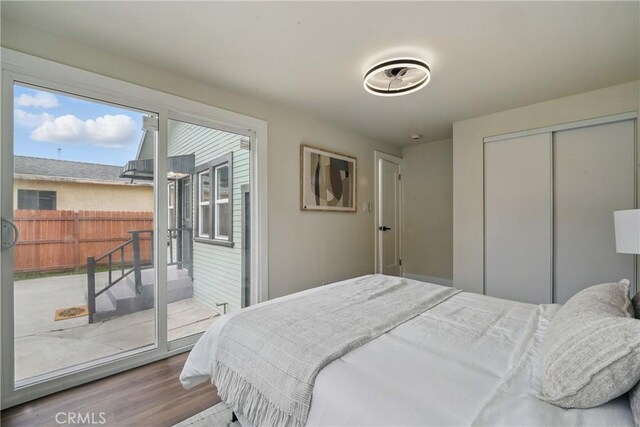 8680 Evergreen Ave, South Gate, CA 90280 - bedroom with access to outside, wood finished floors, and a closet