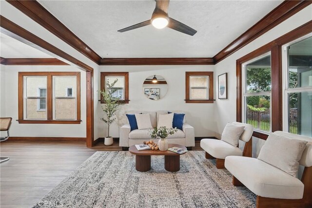 8680 Evergreen Ave, South Gate, CA 90280 - living room with wood finished floors, ceiling fan, and crown molding